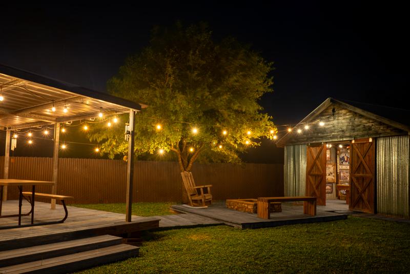 Backyard seating with string lights and game building