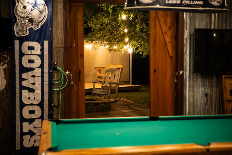 Mancave looking out barn doors to outdoor seating