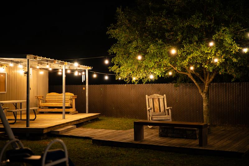 Outdoor seating and string lights in backyard tree